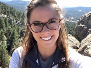 Clinical psychologist smiling outdoors in Colorado Springs and Denver offering supportive care and guidance.